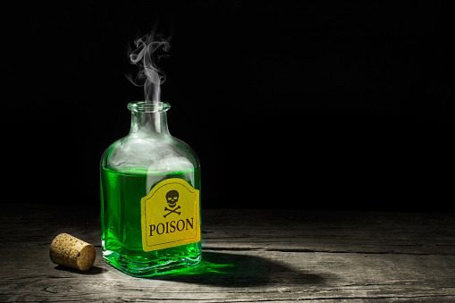 The poison is a green liquid in a glass vial. A deadly potion with a skull and bones on the label. Copy space for text. 3D rendering