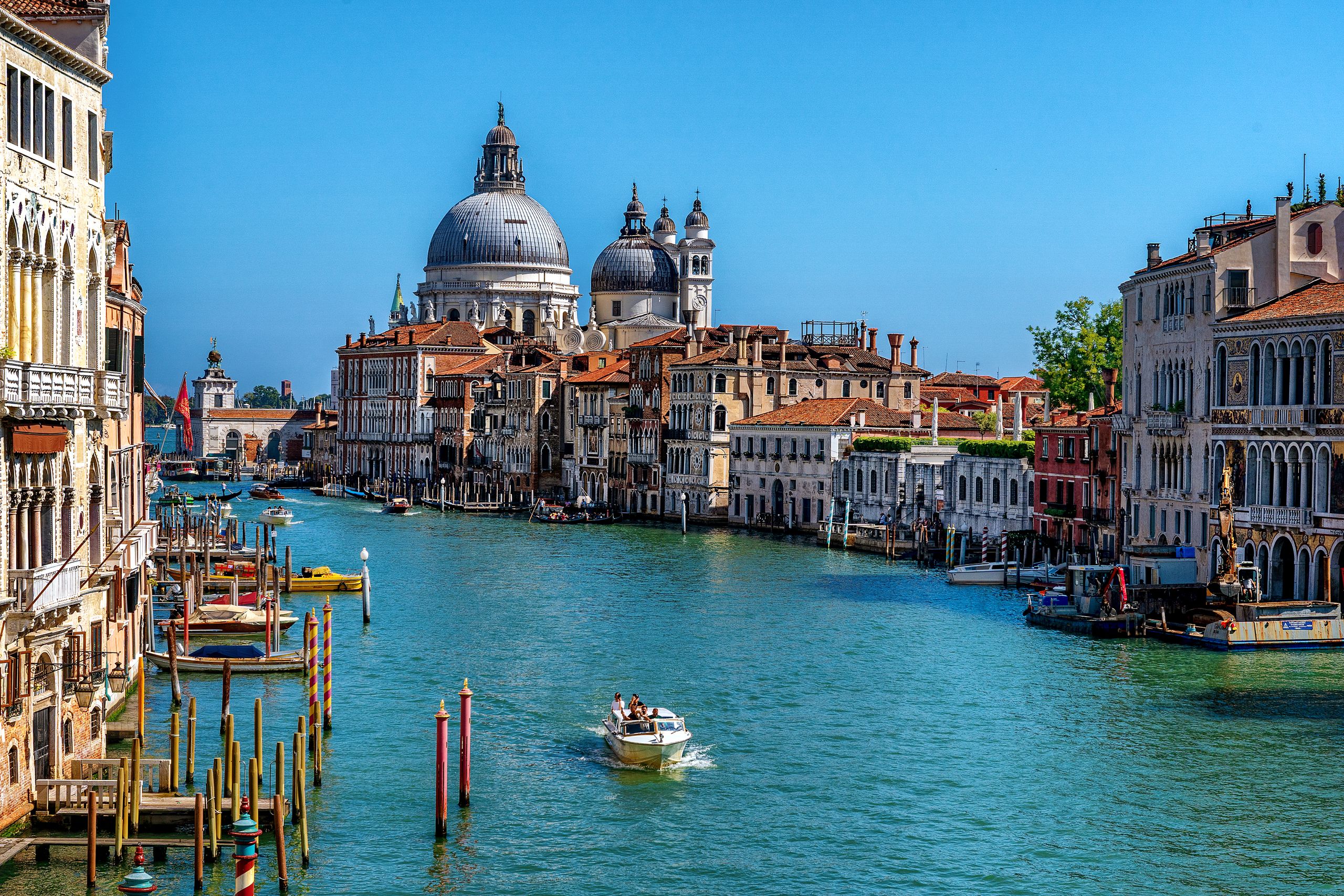 Stunning daytime view of the Grand Canal in Venice, featuring gondolas and historic architecture.