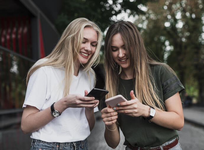 Learn Cebuano app being used on two phones in the hands of two women